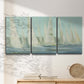 Three-panel canvas wall art featuring sailboats silhouetted at sunrise, displayed in a minimalist living room above a console table.