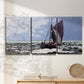 Three-panel canvas wall art featuring stormy sea with crashing waves, displayed in a minimalist living room above a console table.