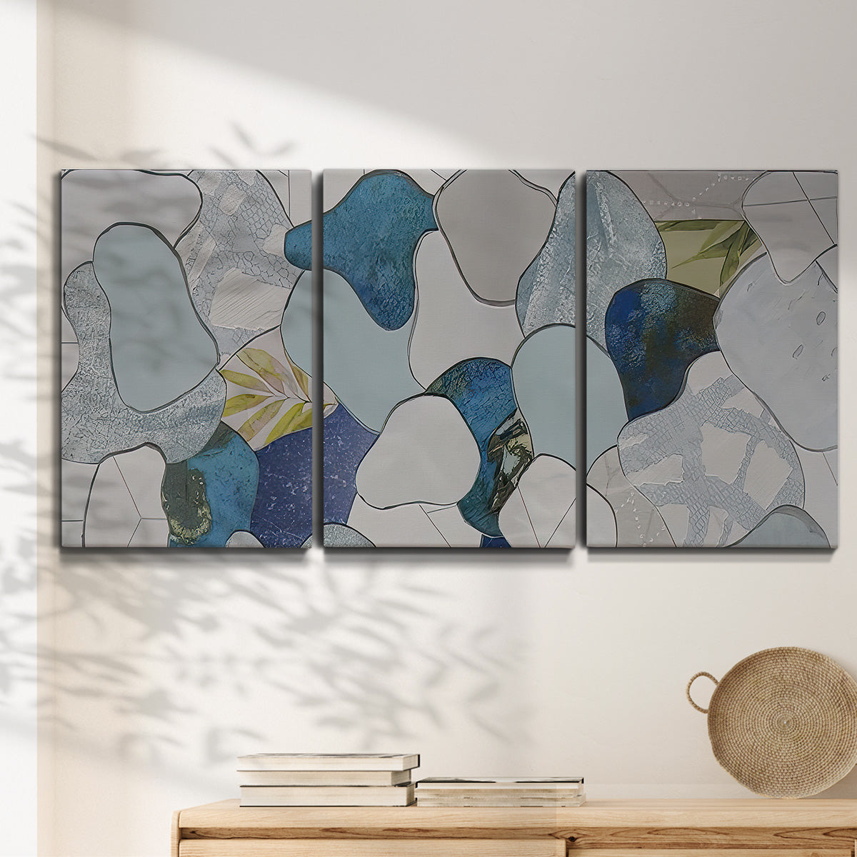 Three-panel canvas wall art featuring mid century geometric pink abstraction, displayed in a minimalist living room above a console table.