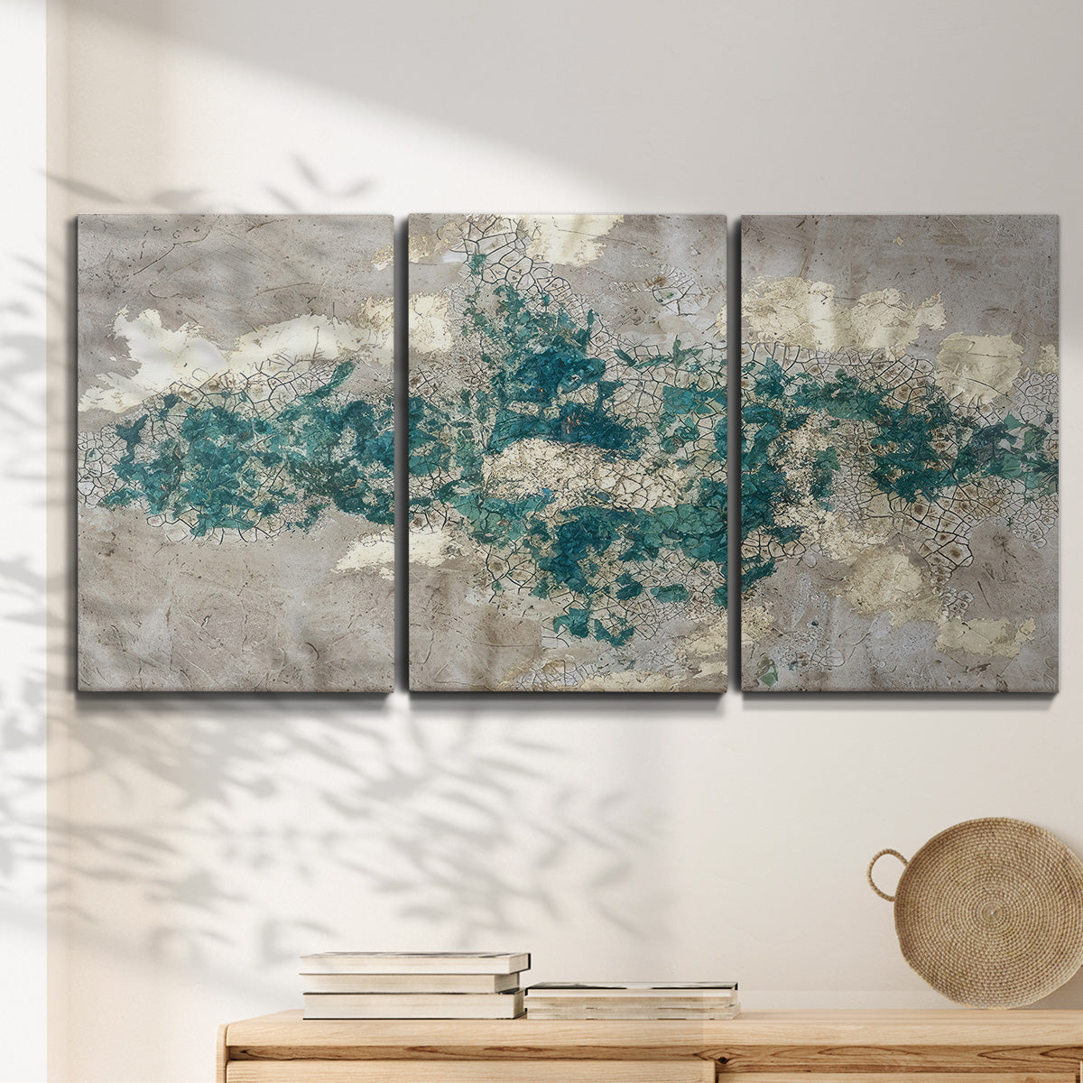 Three-panel canvas wall art featuring layered mineral abstract textures, displayed in a minimalist living room above a console table.