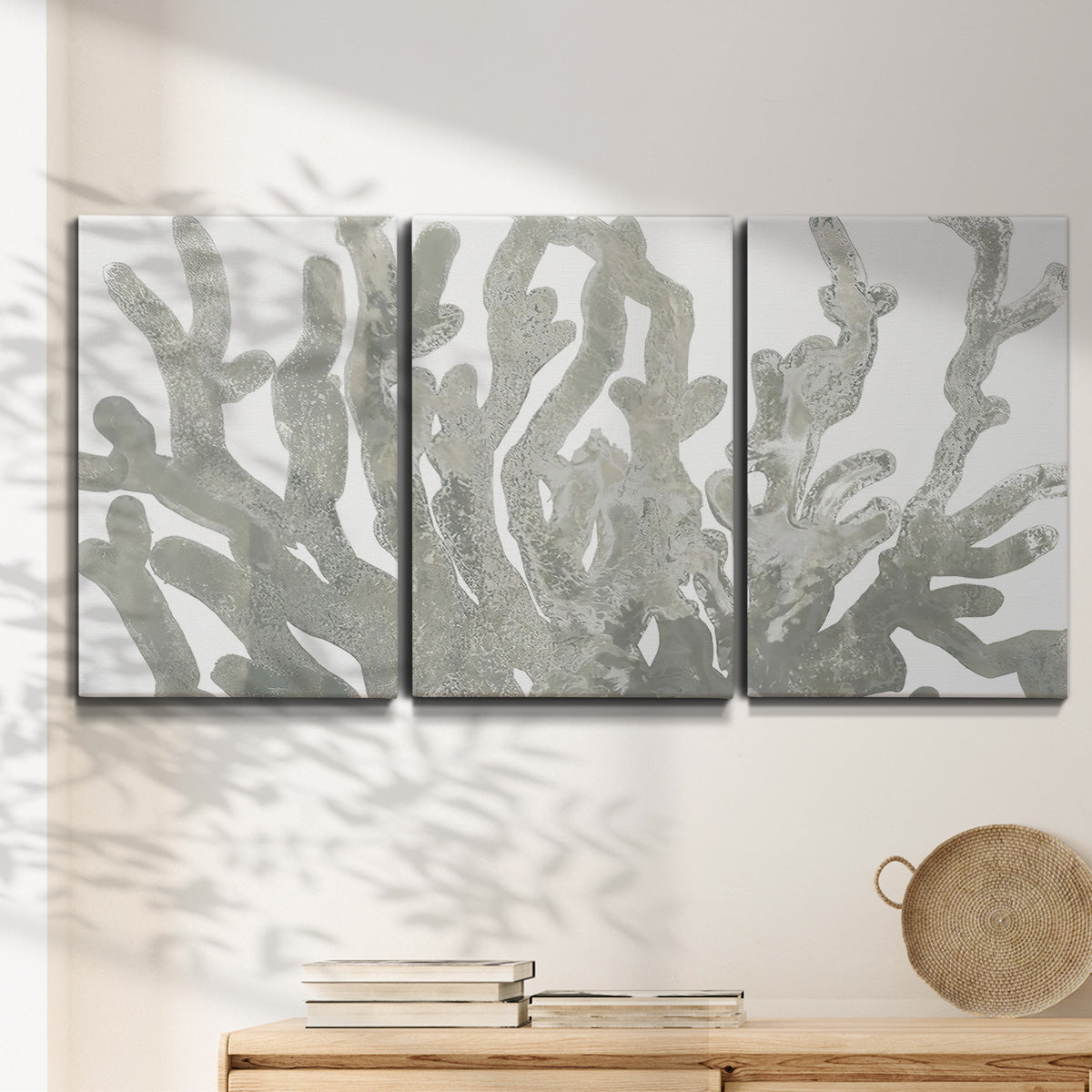 Three-panel canvas wall art featuring monochrome coral texture study, displayed in a minimalist living room above a console table.