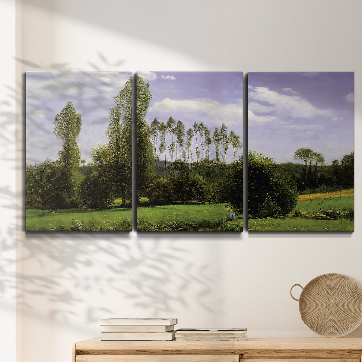 Three-panel canvas wall art featuring open landscape near le havre, displayed in a minimalist living room above a console table.