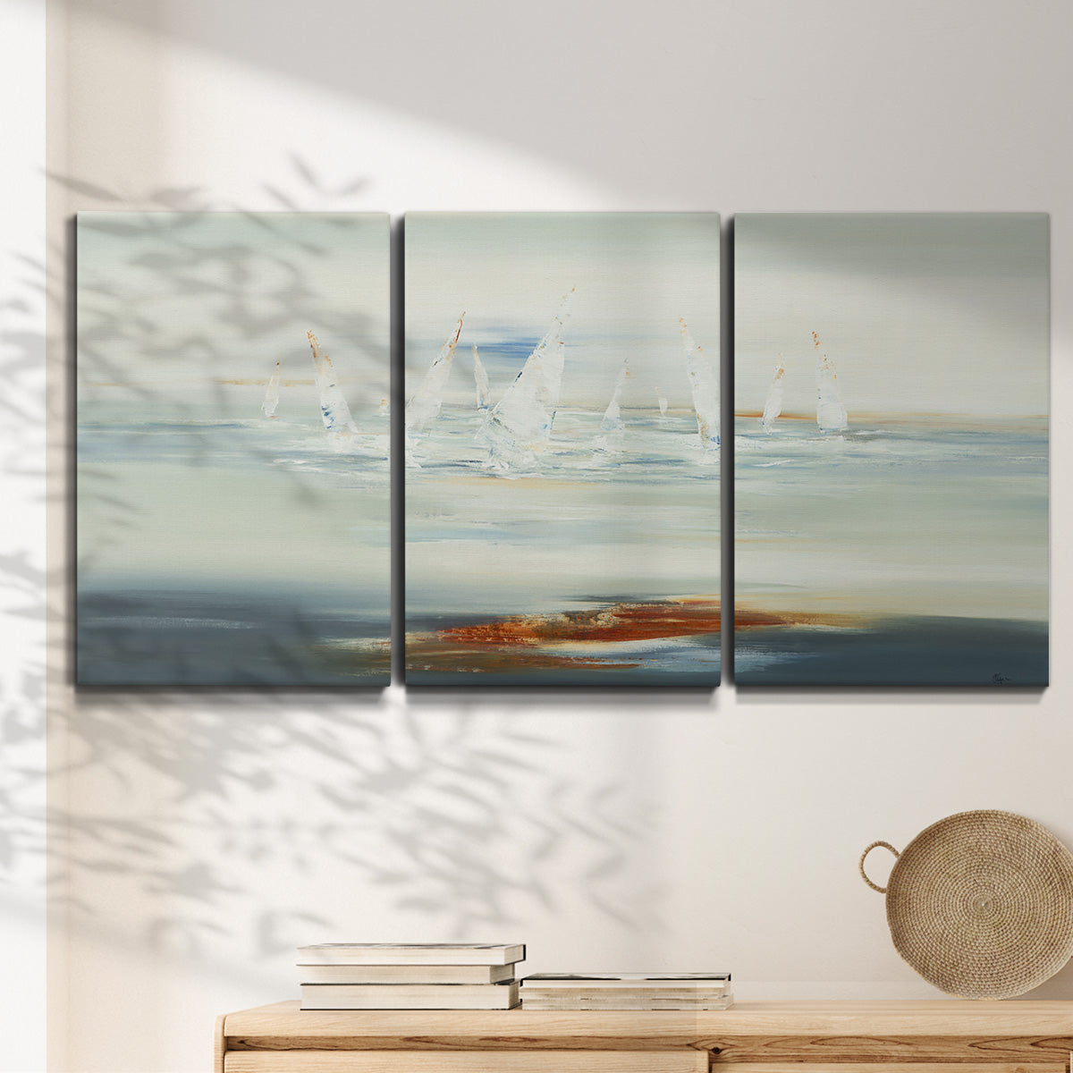 Three-panel canvas wall art featuring nautical abstract suggesting drifting calm, displayed in a minimalist living room above a console table.