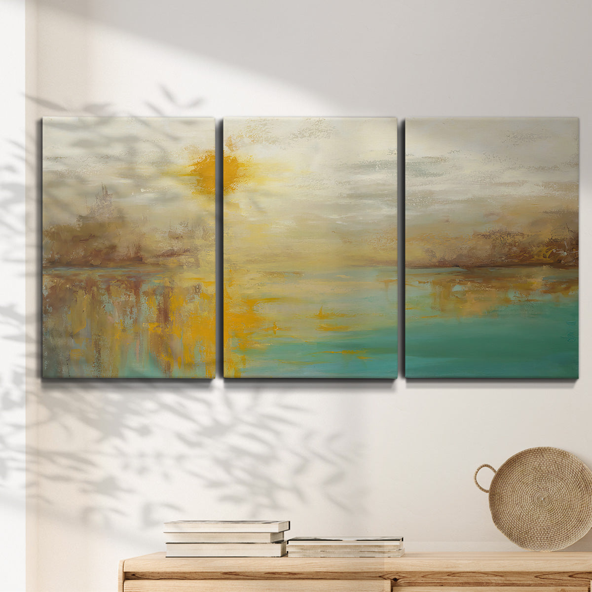 Three-panel canvas wall art featuring warm abstract end of summer palette, displayed in a minimalist living room above a console table.