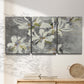 Three-panel canvas wall art featuring delicate floral symbolic arrangement, displayed in a minimalist living room above a console table.