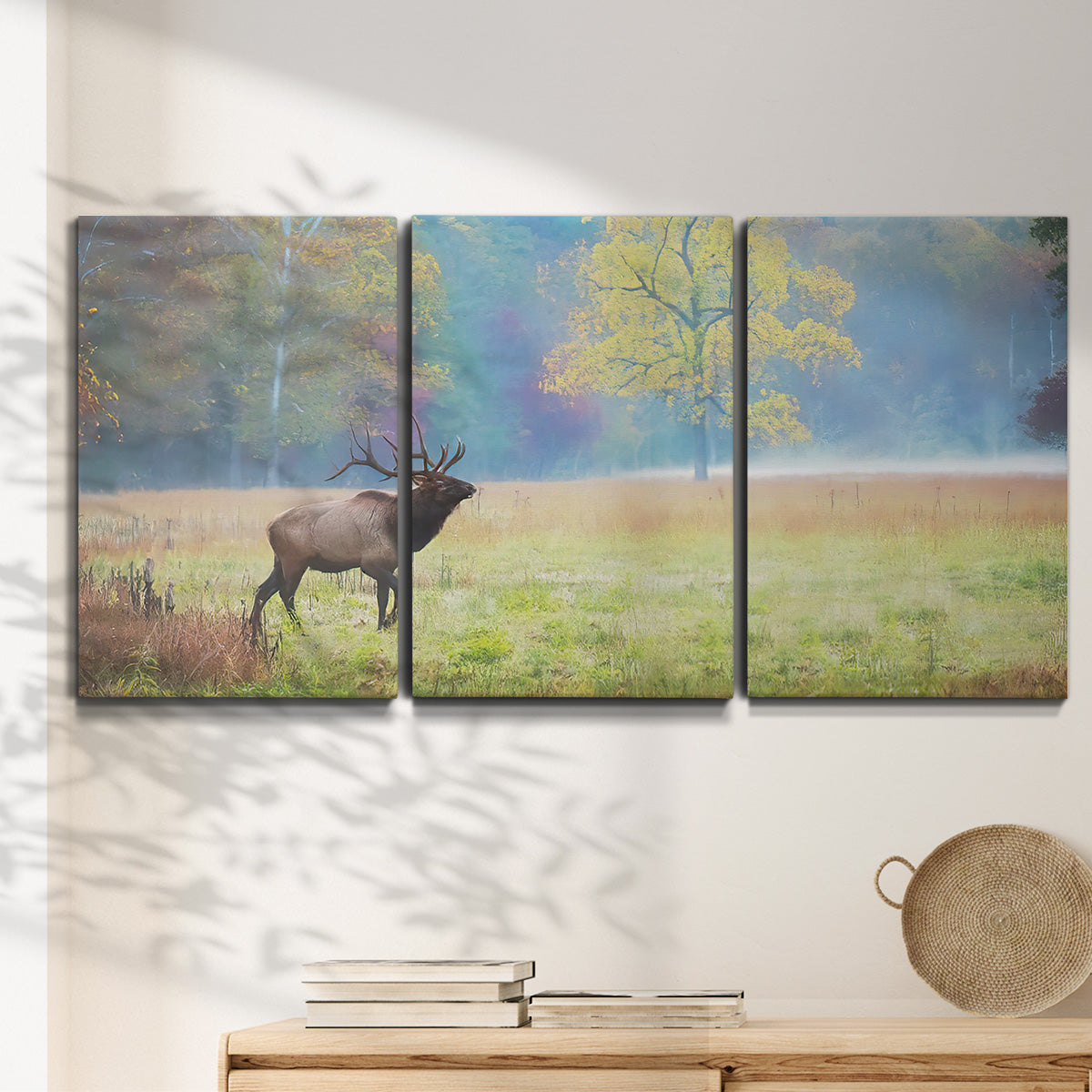 Three-panel canvas wall art featuring resting animals in open field, displayed in a minimalist living room above a console table.