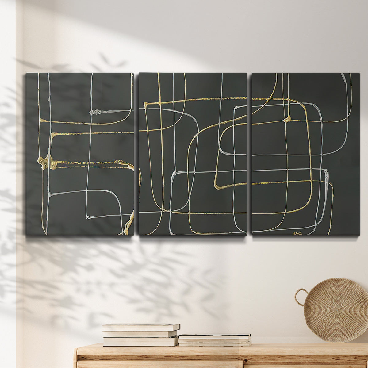 Three-panel canvas wall art featuring linear abstract conduit pattern, displayed in a minimalist living room above a console table.