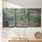 Three-panel canvas wall art featuring water lilies with arched bridge, displayed in a minimalist living room above a console table.