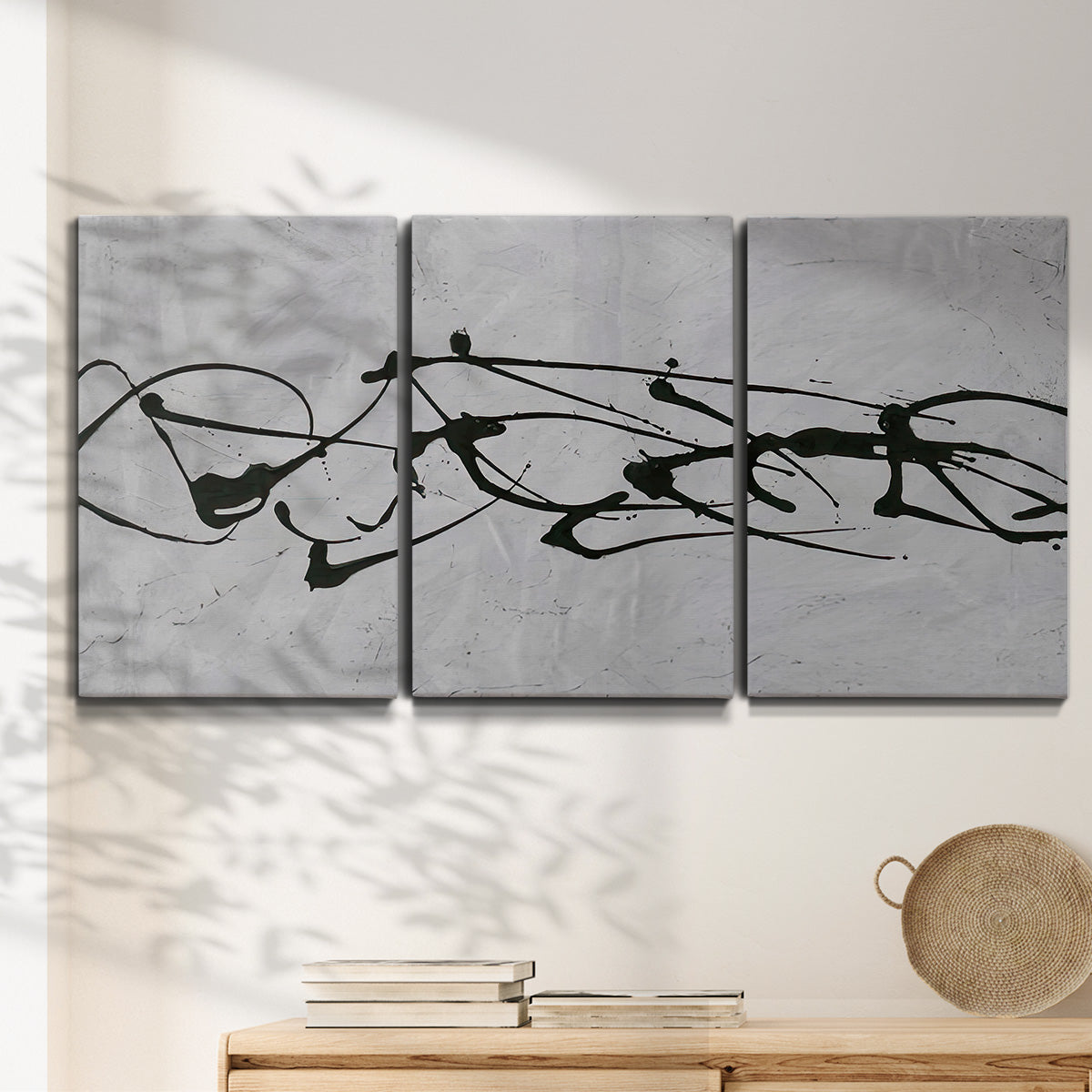 Three-panel canvas wall art featuring minimal abstract frequency lines, displayed in a minimalist living room above a console table.