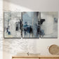 Three-panel canvas wall art featuring cool abstract winter color wash, displayed in a minimalist living room above a console table.