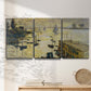 Three-panel canvas wall art featuring working harbor with boats, displayed in a minimalist living room above a console table.