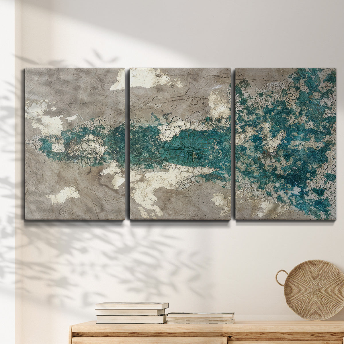 Three-panel canvas wall art featuring layered mineral abstract textures, displayed in a minimalist living room above a console table.