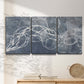 Three-panel canvas wall art featuring coastal shoreline at golden hour, displayed in a minimalist living room above a console table.