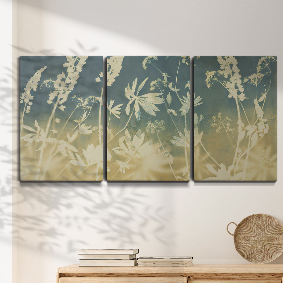 Three-panel canvas wall art featuring lupine flowers in seasonal bloom, displayed in a minimalist living room above a console table.