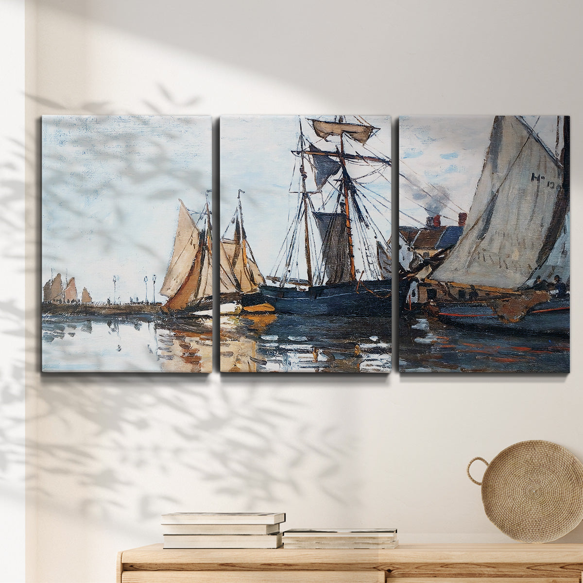 Three-panel canvas wall art featuring fishing boats navigating open water, displayed in a minimalist living room above a console table.