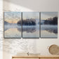 Three-panel canvas wall art featuring misty water landscape photograph, displayed in a minimalist living room above a console table.