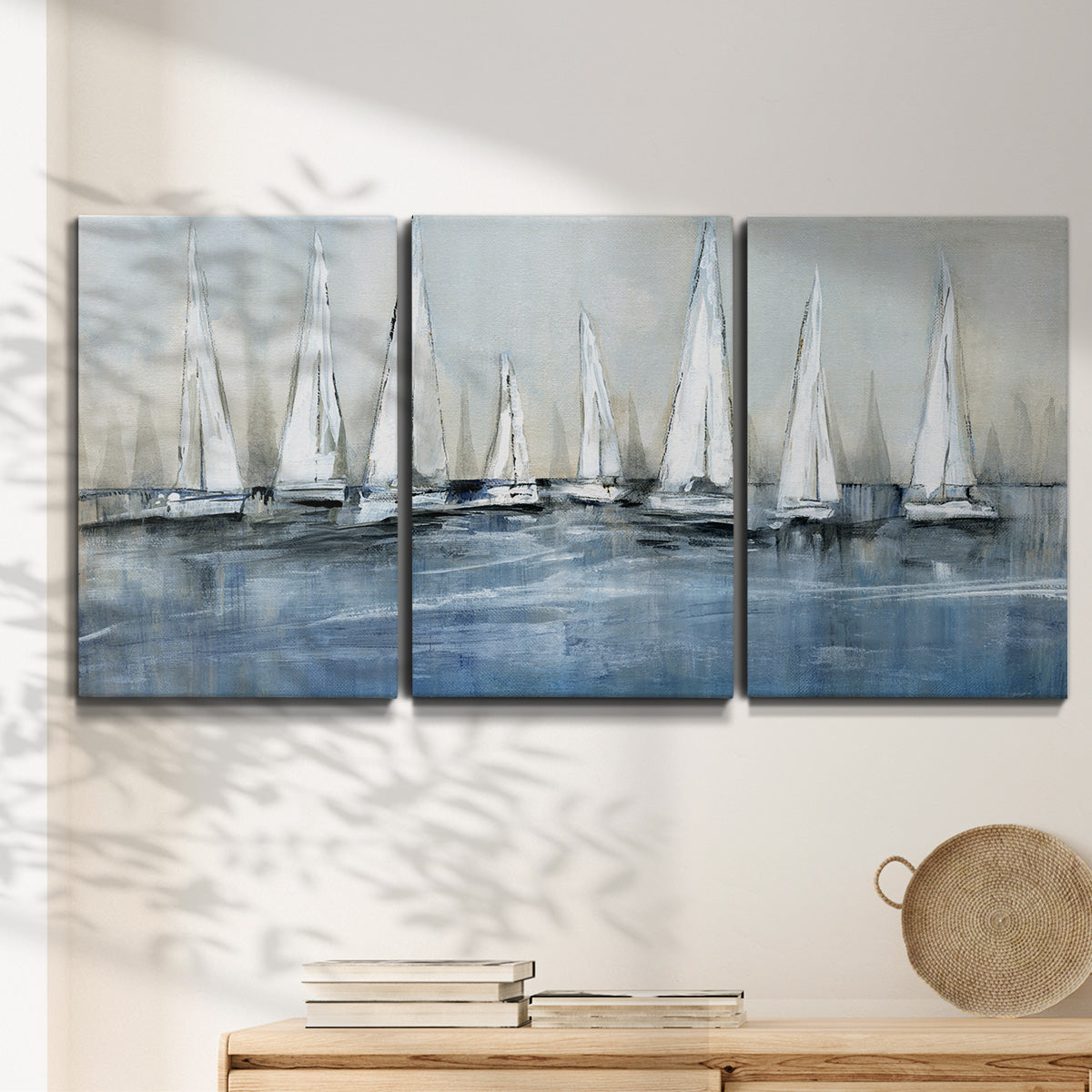 Three-panel canvas wall art featuring still life with pears and grapes, displayed in a minimalist living room above a console table.