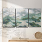 Three-panel canvas wall art featuring lush green hillside rolling landscape, displayed in a minimalist living room above a console table.