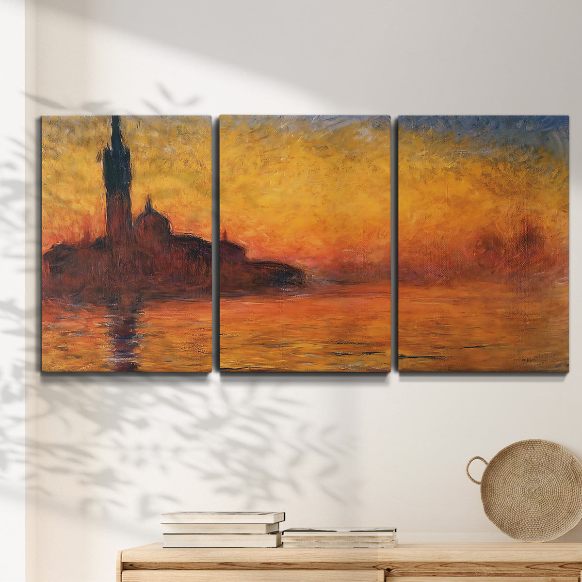 Three-panel canvas wall art featuring Venetian church at sunset, displayed in a minimalist living room above a console table.