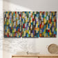Three-panel canvas wall art featuring colorful confetti style abstraction, displayed in a minimalist living room above a console table.