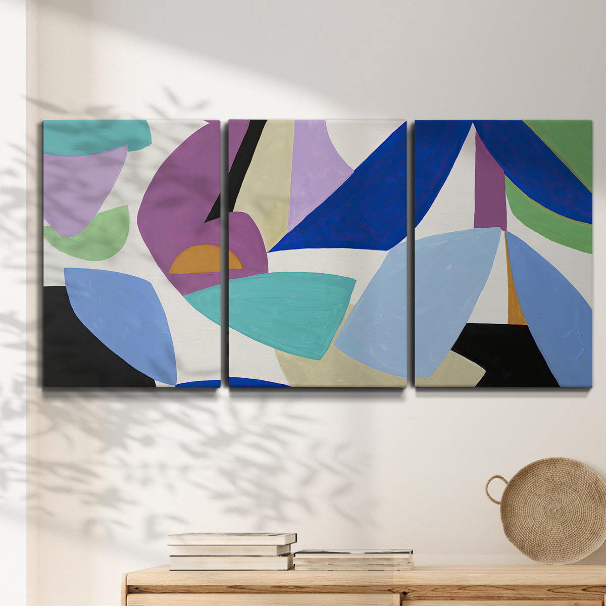 Three-panel canvas wall art featuring colorful abstract homage to modernism, displayed in a minimalist living room above a console table.