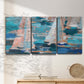 Three-panel canvas wall art featuring graphic pop style sailboats, displayed in a minimalist living room above a console table.