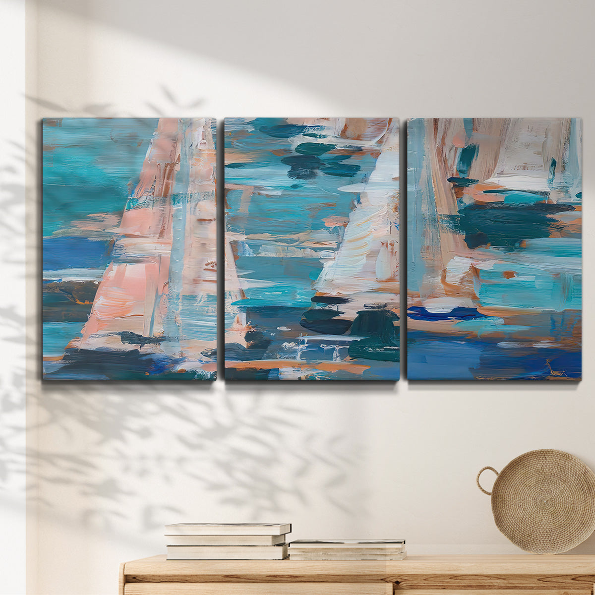 Three-panel canvas wall art featuring graphic pop style sailboats, displayed in a minimalist living room above a console table.
