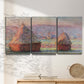 Three-panel canvas wall art featuring winter grainstacks glowing at sunset, displayed in a minimalist living room above a console table.