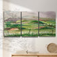Three-panel canvas wall art featuring rainy landscape with soft atmosphere, displayed in a minimalist living room above a console table.