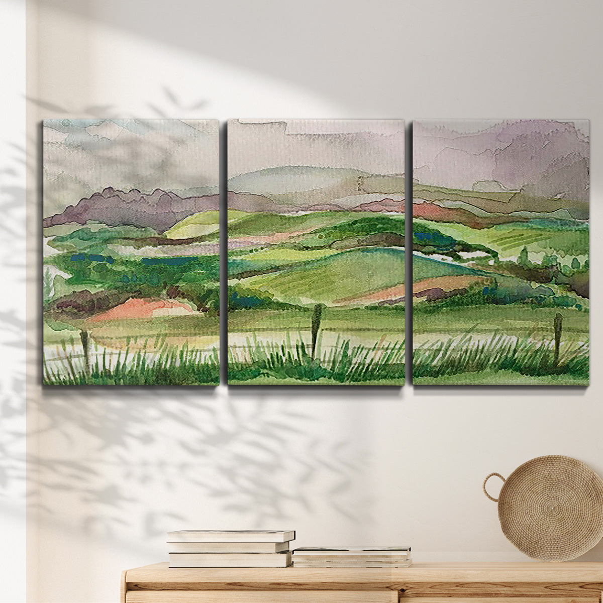 Three-panel canvas wall art featuring rainy landscape with soft atmosphere, displayed in a minimalist living room above a console table.