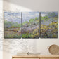Three-panel canvas wall art featuring spring orchard in full bloom, displayed in a minimalist living room above a console table.