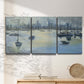 Three-panel canvas wall art featuring anchored boats near shoreline, displayed in a minimalist living room above a console table.