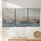 Three-panel canvas wall art featuring abstract bridge landscape in cyan, displayed in a minimalist living room above a console table.