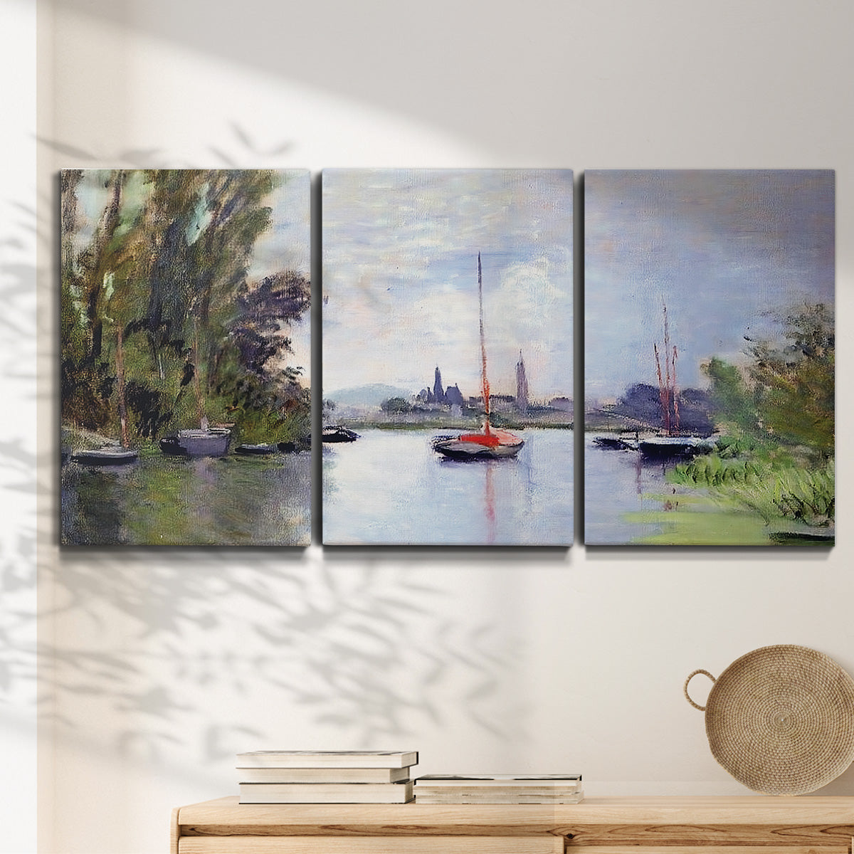 Three-panel canvas wall art featuring river view with boats and reflections, displayed in a minimalist living room above a console table.