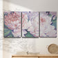 Three-panel canvas wall art featuring soft pink peonies in bloom, displayed in a minimalist living room above a console table.