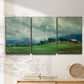 Three-panel canvas wall art featuring wide pastoral valley landscape, displayed in a minimalist living room above a console table.