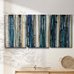 Three-panel canvas wall art featuring vertical blue abstract streaks, displayed in a minimalist living room above a console table.