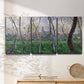 Three-panel canvas wall art featuring spring landscape along river, displayed in a minimalist living room above a console table.