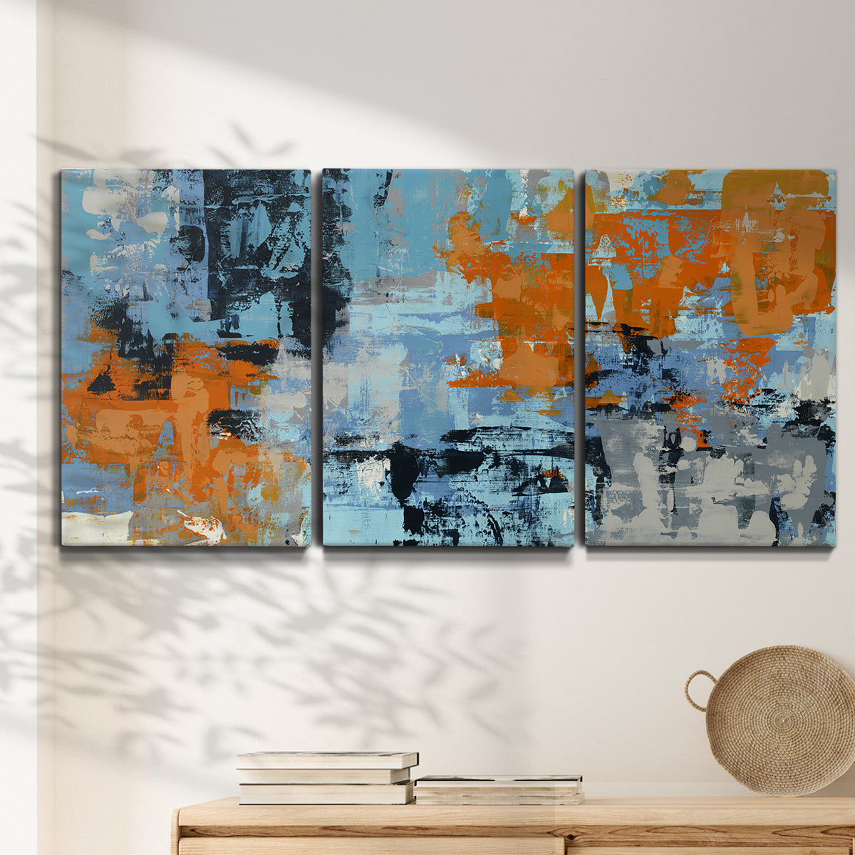 Three-panel canvas wall art featuring mid century abstract playground shapes, displayed in a minimalist living room above a console table.