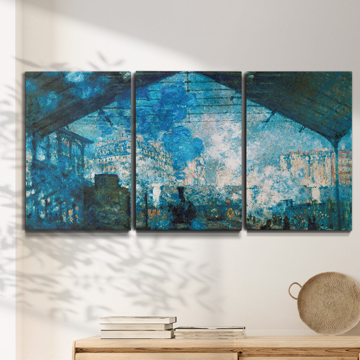Three-panel canvas wall art featuring railway station filled with steam, displayed in a minimalist living room above a console table.