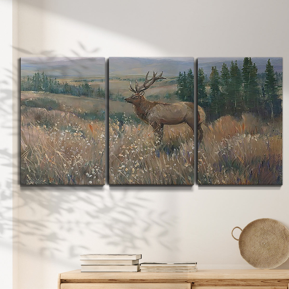 Three-panel canvas wall art featuring western wildlife standing in grassland, displayed in a minimalist living room above a console table.
