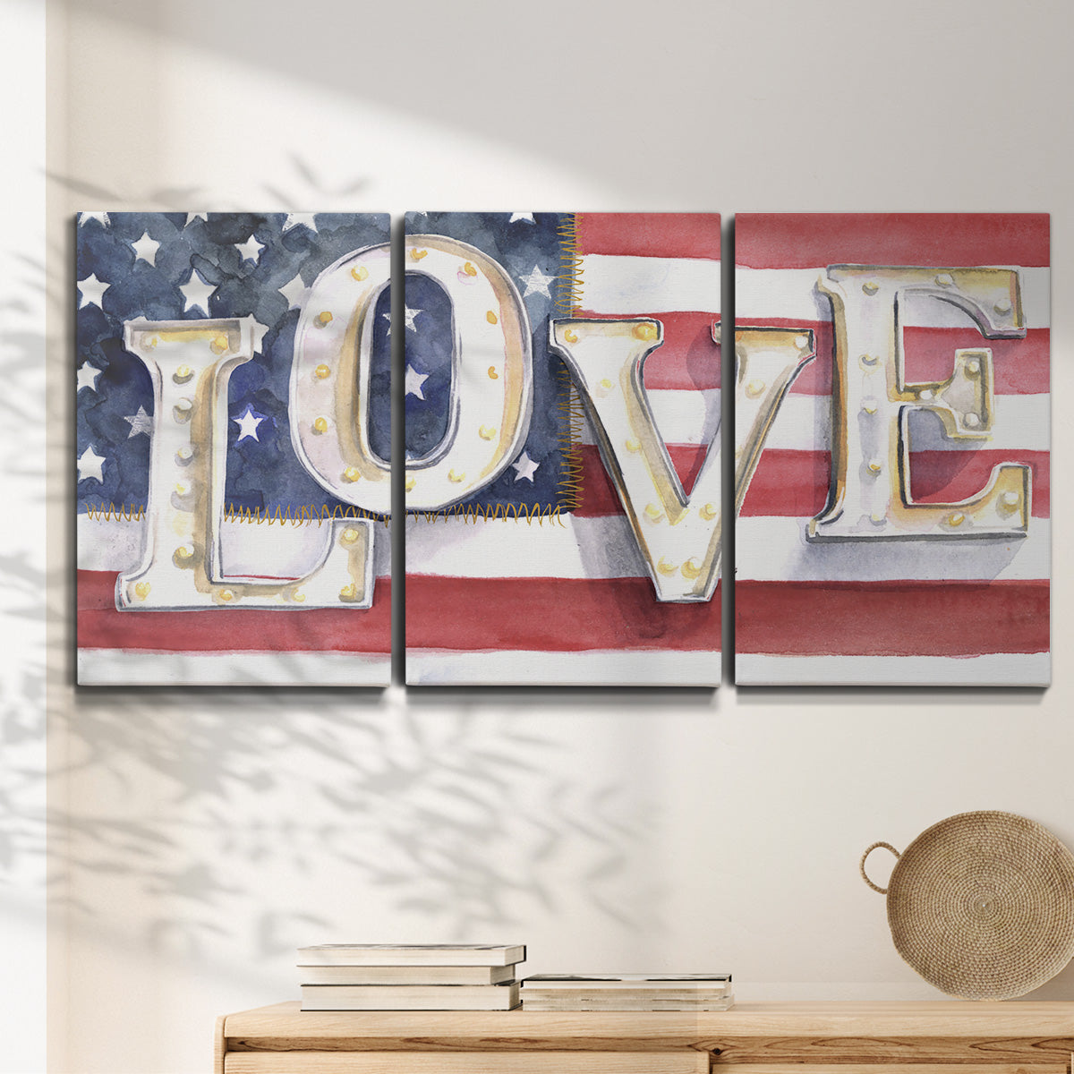 Three-panel canvas wall art featuring patriotic rustic typography art, displayed in a minimalist living room above a console table.