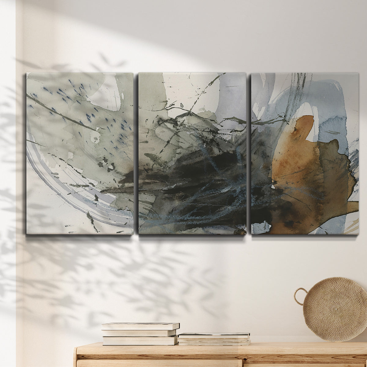 Three-panel canvas wall art featuring dynamic circular abstract motion, displayed in a minimalist living room above a console table.
