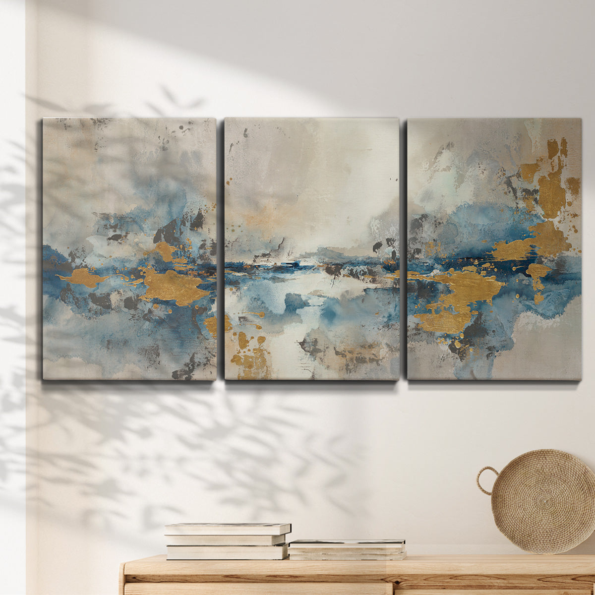 Three-panel canvas wall art featuring abstract soft morning light, displayed in a minimalist living room above a console table.