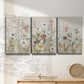 Three-panel canvas wall art featuring loose farmhouse style floral painting, displayed in a minimalist living room above a console table.