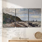 Three-panel canvas wall art featuring open sea along rocky shore, displayed in a minimalist living room above a console table.