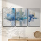 Three-panel canvas wall art featuring minimal urban skyline watercolor, displayed in a minimalist living room above a console table.