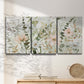 Three-panel canvas wall art featuring vintage floral botanical sketchbook, displayed in a minimalist living room above a console table.