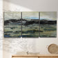 Three-panel canvas wall art featuring muted abstract landscape study, displayed in a minimalist living room above a console table.