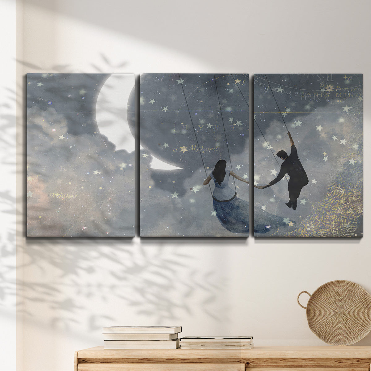 Three-panel canvas wall art featuring surreal celestial romantic scene, displayed in a minimalist living room above a console table.